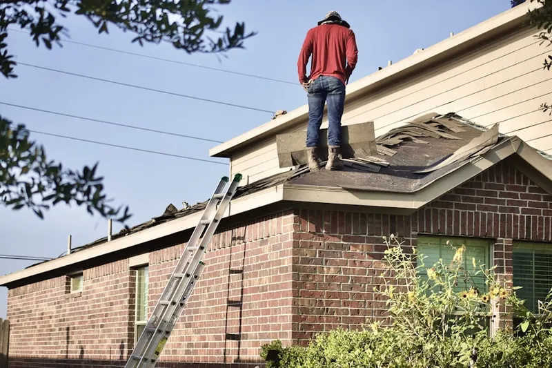 Professional roofer working on a residential roof in St. Joseph